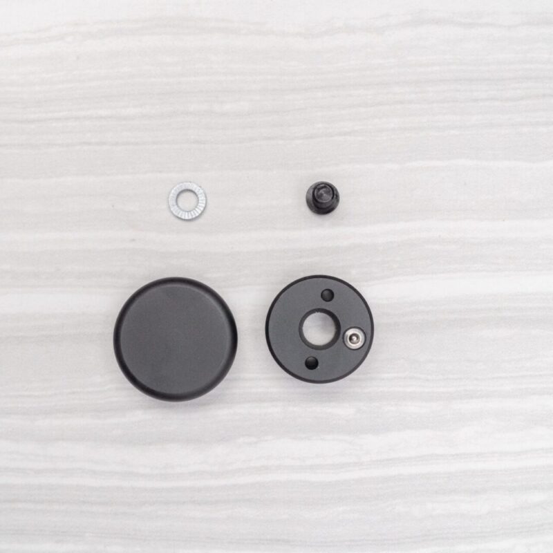 Black circular components on light surface.