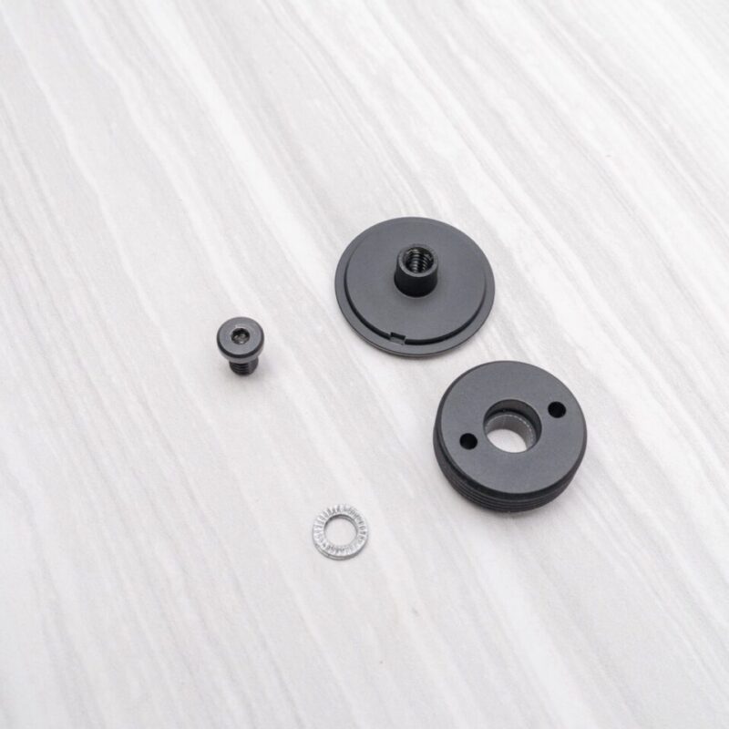 Black mechanical parts on a white surface.