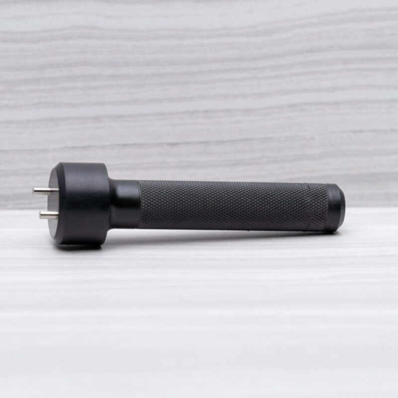 Black handheld device on a light surface.
