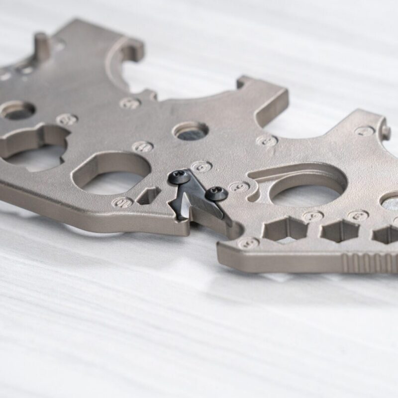 Metallic mechanical component on white surface.