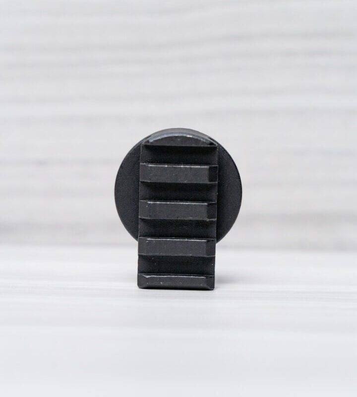 Black round object with textured surface.