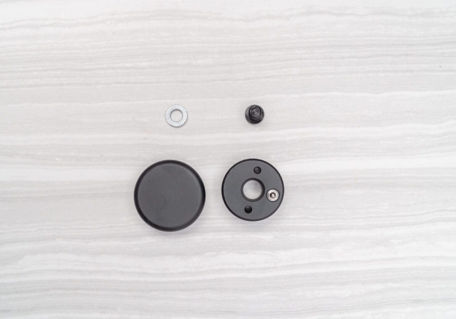 Black circular components on light surface.