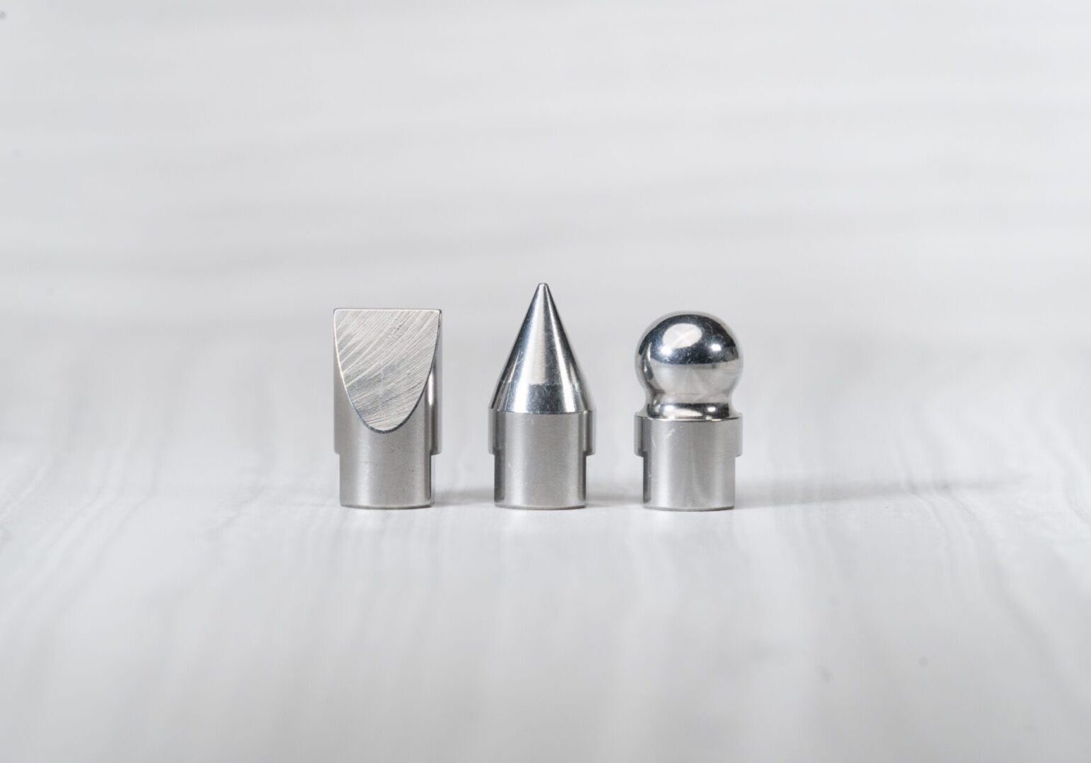 Three metal objects with different shapes.