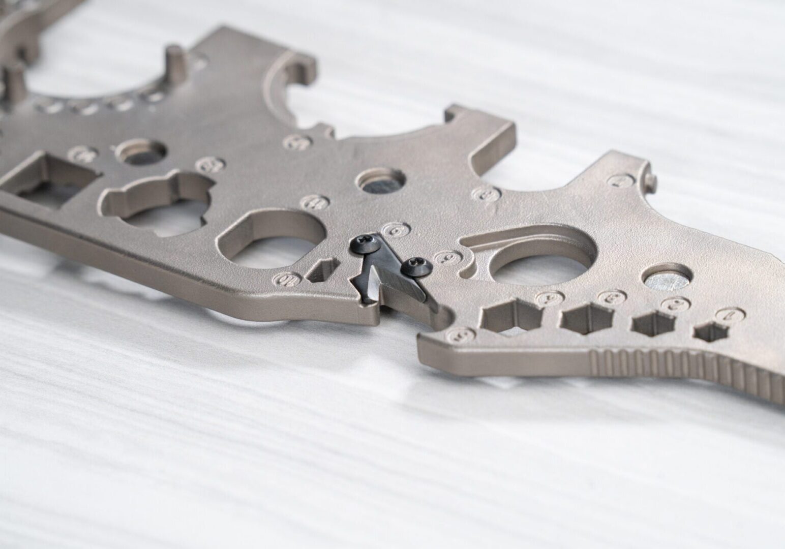 Metallic mechanical component on white surface.